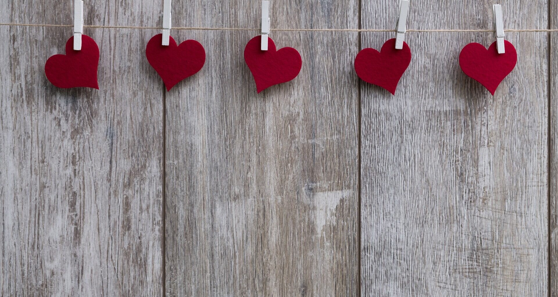 Paper hearts attached to a string by paperclips
